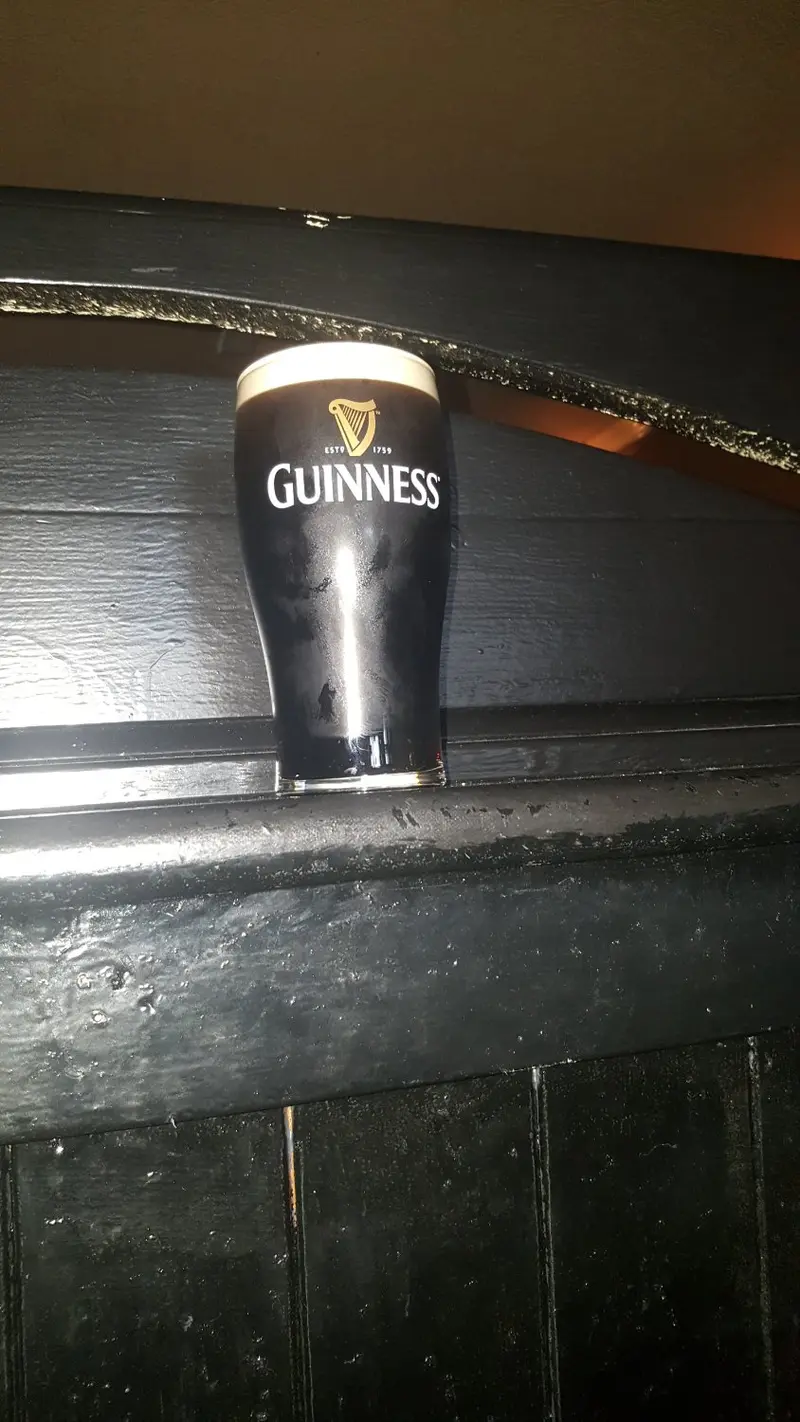 A pint of Guinness resting on a dark wooden snug in Furey's